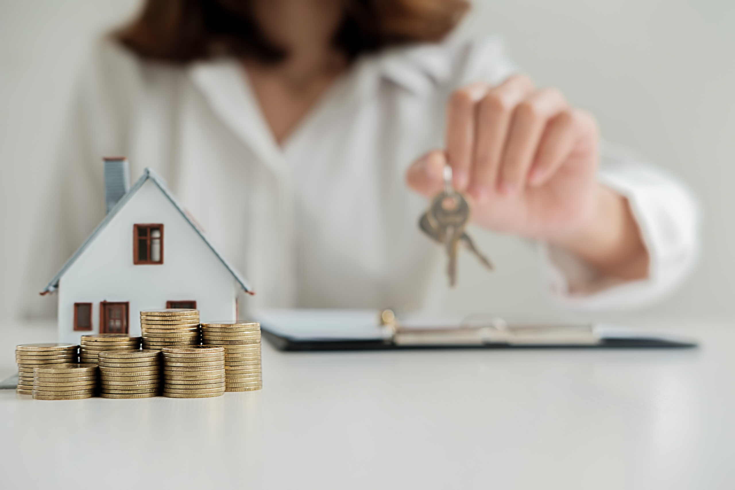 Real estate agent giving the keys to customer for deal contract